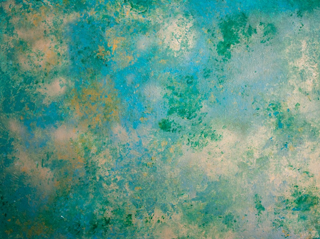An abstract acrylic painting. It has a cloud like print with different shades of bright light blue, emerald green, a darker shade canary gold and a lighter shade banana gold.